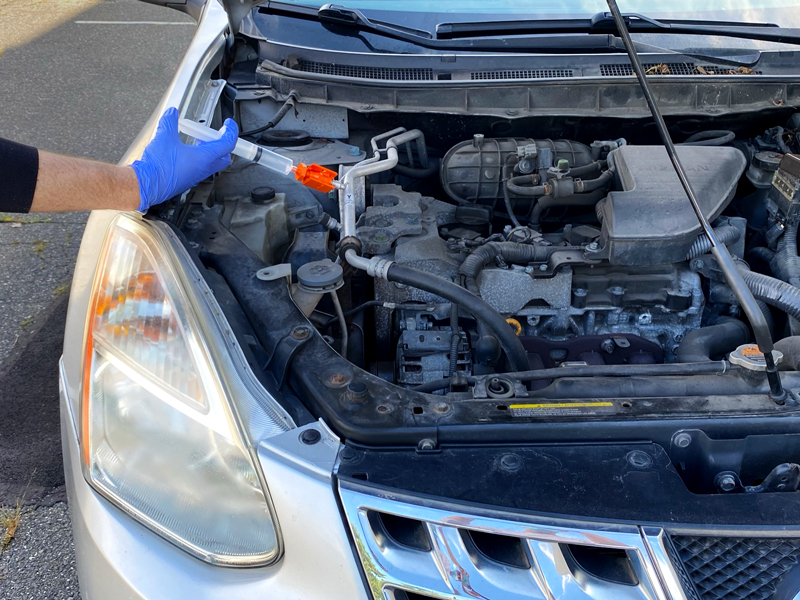 Injecting LeakFinder AC Leak Sealant in Car